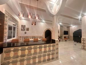 a lobby with a counter with a fireplace in it at Villa Koebi in Monte ʼArrouit