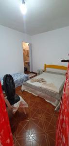 a bedroom with two beds and a tire on the floor at Casa Caiçara Centro in Paraty