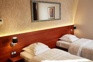 Postel nebo postele na pokoji v ubytování Hotel&Spa Kameleon