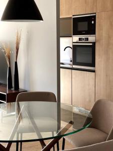 - un salon avec une table en verre et une chaise dans l'établissement Apartamento deluxe en Pocitos_Life Veintiseis Apartments, à Montevideo