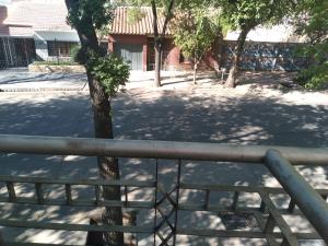una barandilla de metal junto a un árbol en un patio en La Florentina en Mendoza