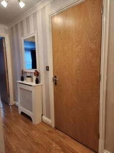 a room with a door and a table and a window at RGM Hatfield 2 Bedroom Apartment in Hatfield