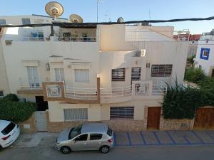 a car parked in front of a building at The perfect Riad Al Salam apartment in Agadir