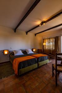 a bedroom with a large bed in a room at Horta da Quinta in Mértola