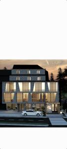 a rendering of a building with a car in front at Gondola Apartments in Jahorina