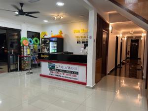 a lobby with a waiting area with a wall wave sign at VILLA WANIE INN in Setiu +49 photos