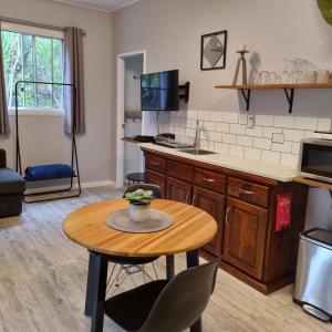 a living room with a table and a kitchen at Bluegrass BnB in Bundaberg