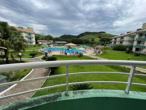 a view of a pool from a balcony of a resort at Apartamento/Flat - Condominio Village - Aldeia das Águas Park Resort. in Barra do Piraí +6 photos