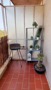 a small balcony with a table and potted plants at Charming Avenue Apartment in Faro
