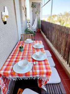 a table with plates on it on a patio at Charming Avenue Apartment in Faro