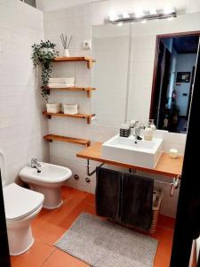 a bathroom with a sink and a toilet and a mirror at Charming Avenue Apartment in Faro