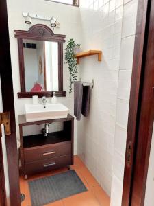 a bathroom with a sink and a mirror at Charming Avenue Apartment in Faro