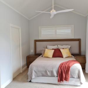 a bedroom with a bed with a white ceiling at Sanctuary Ridge in Tauranga
