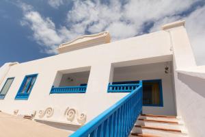 a house with blue and white walls and stairs at Casa Manrique in Famara