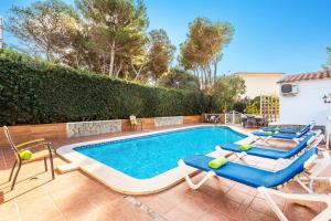 a swimming pool with two lounge chairs and a swimming pool at Villa Tamyan by Villa Plus in Son Parc