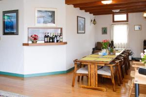 a dining room with a table and a bar at Winterfell Hakuba in Hakuba