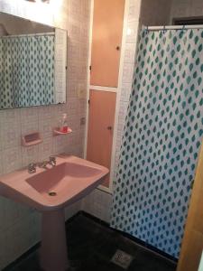 y baño con lavabo rosa y ducha. en Quinta House en Mendoza