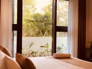a bedroom with a bed and a large window at Finch Tangalle in Tangalle +55 photos