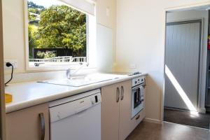 a kitchen with a sink and a window at Turner Heights Townhouses in Queenstown
