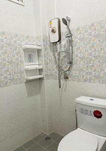 a bathroom with a shower and a toilet at PPN Garden Resort in Suwannaphum