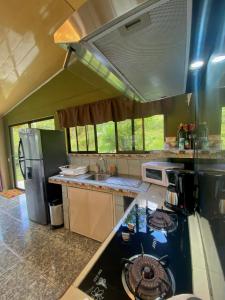 una cucina con lavandino e piano cottura forno superiore di Ferreto`s House a El Castillo