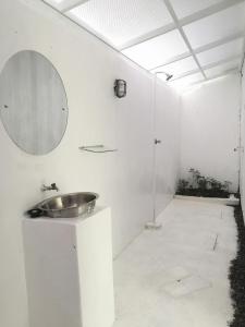 a bathroom with a sink and a mirror on the wall at Kubu Container in Uluwatu