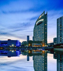 a city skyline with tall buildings and a river at Bayshore Hotel Dalian in Dalian