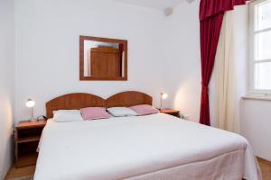 Postel nebo postele na pokoji v ubytování Apartments Lepur