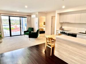 a kitchen and living room with a table and chairs at Sixty Six Boutique Apartments in Hobart