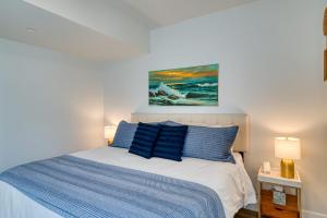 a bedroom with a blue and white bed and a painting at Cypress Penthouse Traverse City Condo in Traverse City