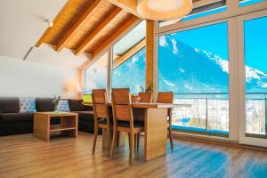 a dining room and living room with a table and chairs at Pension Café Maier in Golling an der Salzach