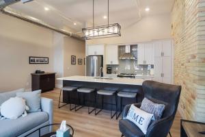 a living room with a couch and a kitchen at Golden Lofts Unit 3 Downtown Traverse City 2bd 2ba in Traverse City