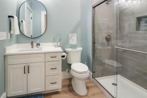 a bathroom with a toilet and a glass shower at Golden Lofts Unit 3 Downtown Traverse City 2bd 2ba in Traverse City +23 photos