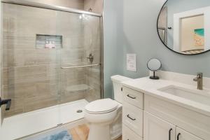 a bathroom with a shower and a toilet and a sink at Golden Lofts Unit 4 Downtown Traverse City 2BD 2BA in Traverse City +28 photos