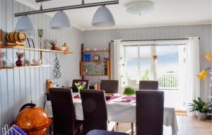 a dining room with a table and chairs at Lovely Home In Utker With Wifi in Utåker