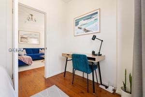 a home office with a desk and a blue chair at Beach-side North Bondi in Sydney