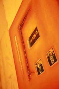 an orange wall with pictures on the wall at Guest house Heysel Laeken Atomium in Brussels