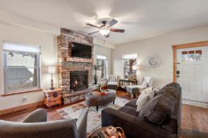 a living room with a couch and a fireplace at Black Bear Cabin with Hot Tub in Woodland Park