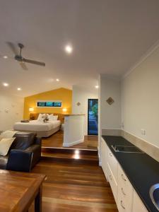 a kitchen and living room with a bed in the background at Kondalilla Eco Resort in Montville