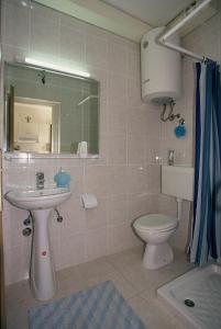 a bathroom with a sink and a toilet at Apartments Boljat in Supetar