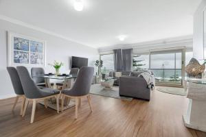a living room with a table and chairs and a couch at Suite 305 Sandcastles 3 Bedroom Deluxe Apartment in Perth