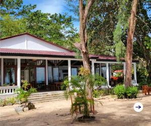 a house with trees in front of it at Bamboo Cottages in Phu Quoc