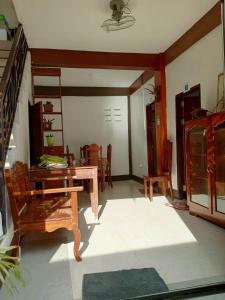 a living room with a wooden table and chairs at DGA Pension House in Coron