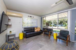 a living room with a black leather couch and chairs at Island View Apt 1 in Arcadia