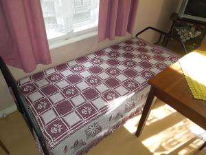 a bench sitting in a room with a window at Holiday Home on Liepajas Street in Aizpute