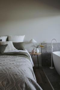 a bedroom with a bed and a bath tub at Sixty6 Acres Sunshine Coast farmstay in Woombye