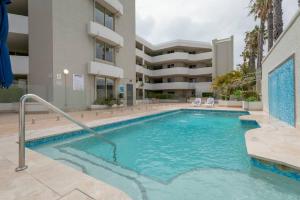 a swimming pool in front of a building at Suite 305 Sandcastles 3 Bedroom Deluxe Apartment in Perth