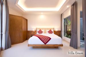 a bedroom with a bed with red pillows at Villa Mia Seminyak - Boutique Villas in Seminyak