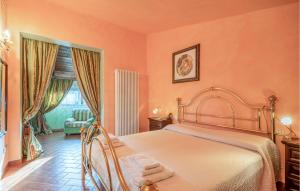 a bedroom with orange walls and a bed with towels on it at 4 Bedroom Lovely Home In San Giovanni in Montefiore dellʼAso