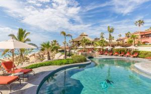 a pool at the resort with chairs and umbrellas at The Club at Hacienda del Mar in Cabo San Lucas